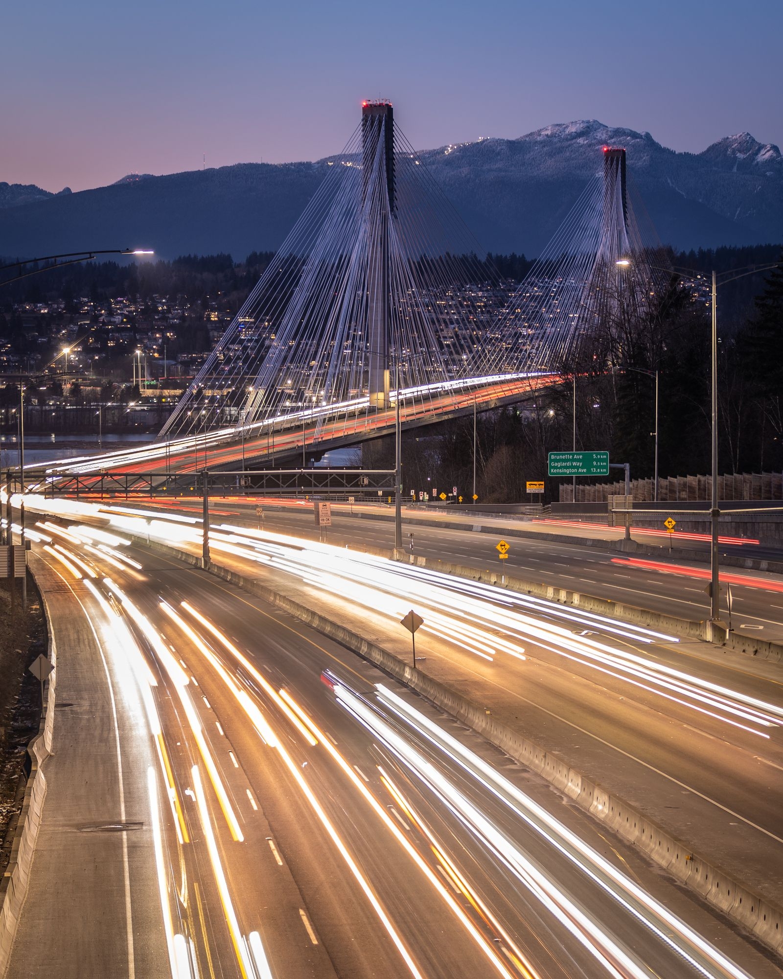 Port Mann Bridge and highway light trails at twilight on the Surrey side of the Fraser River